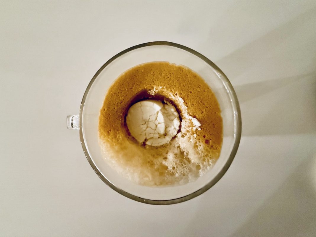 naked nutrition collagen creamer in a cup of coffee