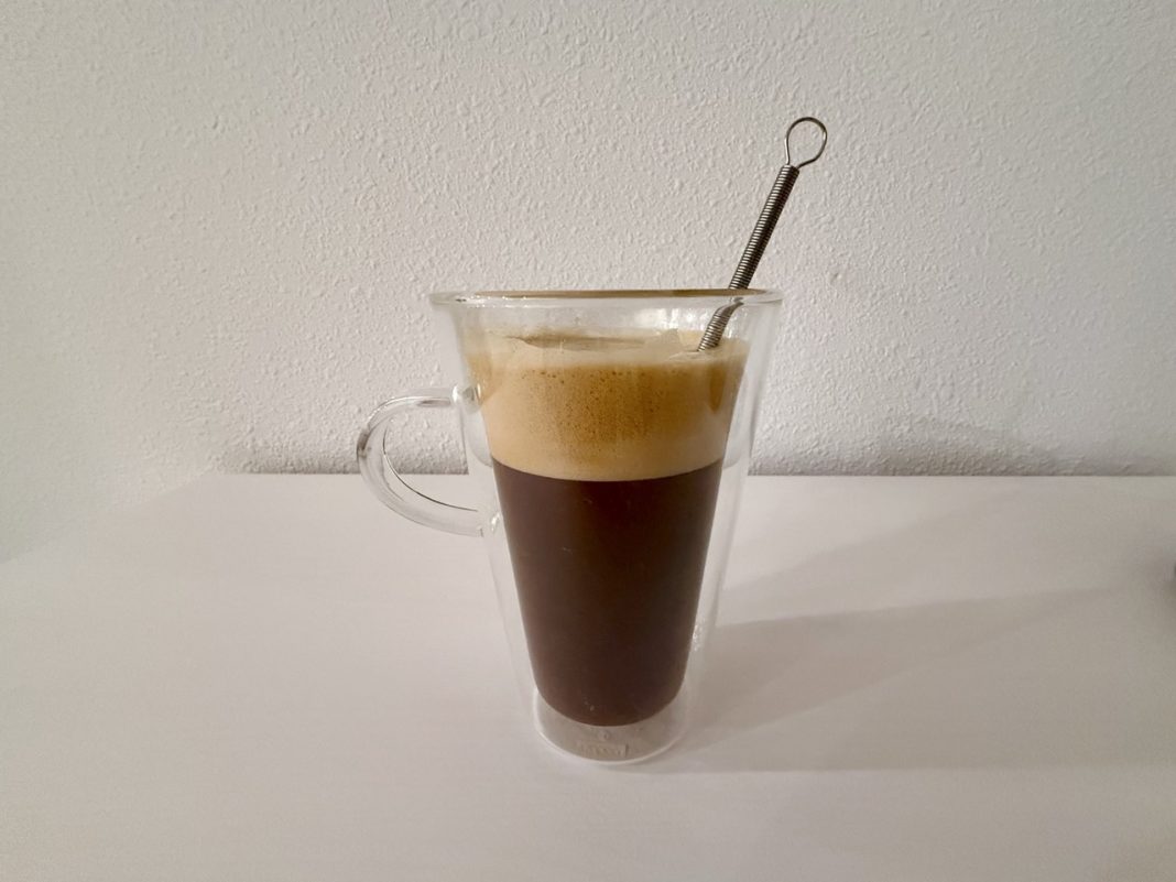 Cup of coffee with naked collagen creamer mixed in