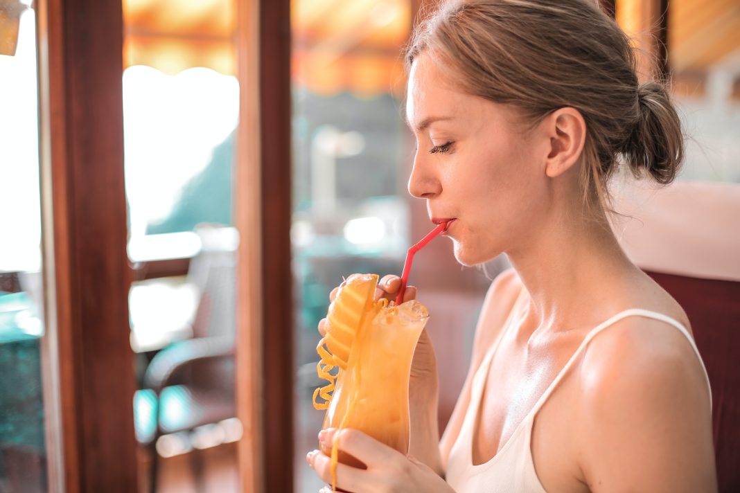 woman drinking from reusable straw