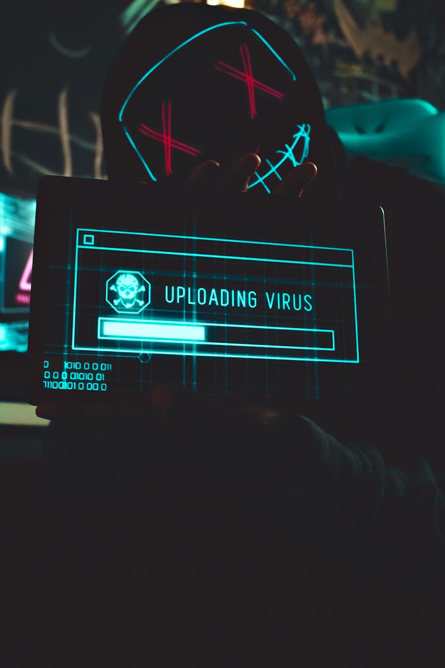 hacker holding screen with virus