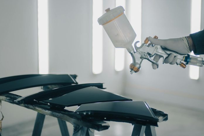 close up of man painting car details