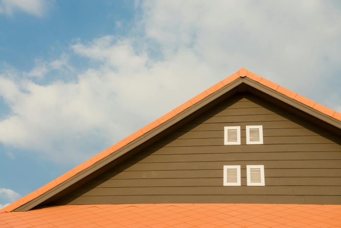orange and gray painted roof under cloudy