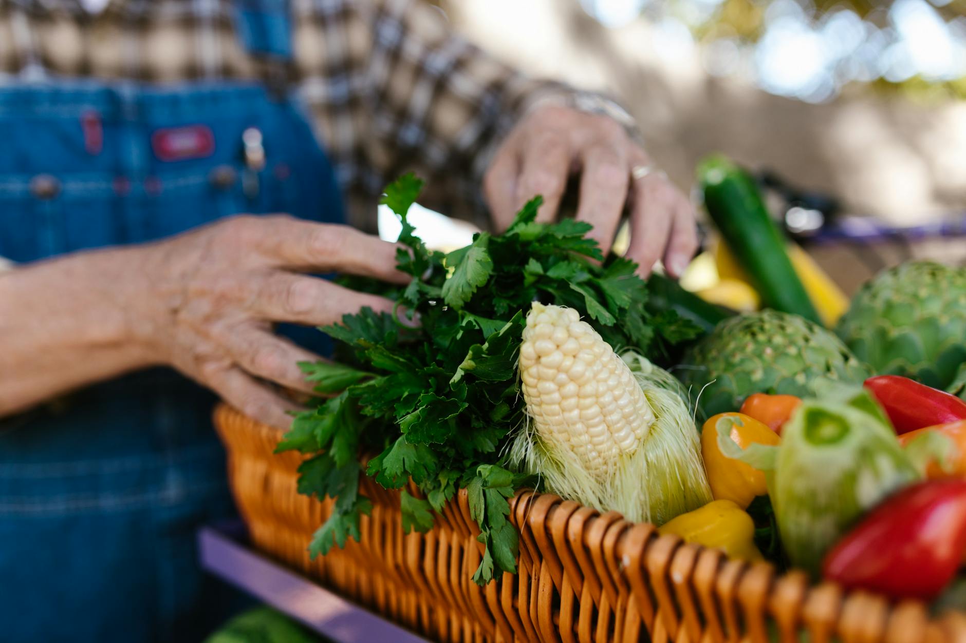a close up shot of a person arranging vegetables in a basket