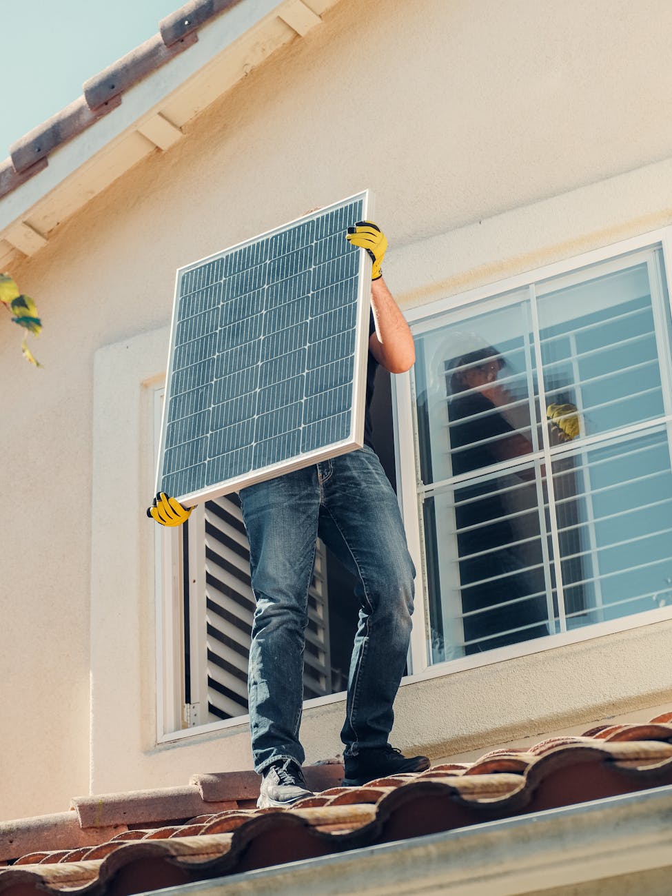 a man carrying solar panel