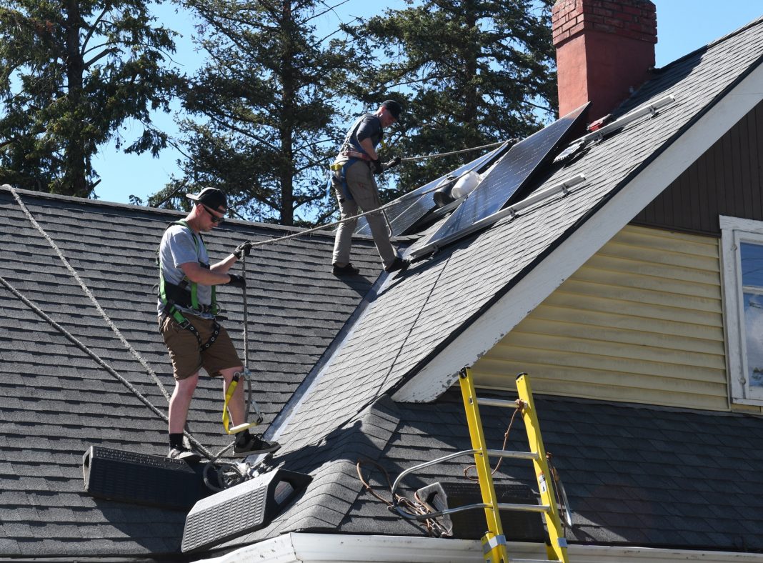 Solar panels being installed, credit Wayne Emde